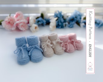 May include: A collection of knitted baby booties in light blue, beige, and pink. Each pair features a rolled cuff and a delicate bow. The image includes text that reads "Knitting Pattern - ENGLISH".