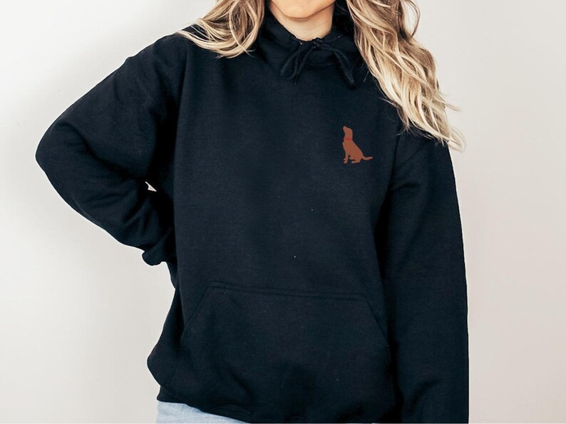 May include: Black hooded sweatshirt with a brown silhouette of a dog on the front.