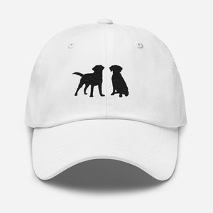 May include: White baseball cap with black embroidered silhouettes of two dogs facing each other.