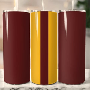 May include: Three stainless steel tumblers. One is maroon, one is maroon with a vertical gold stripe, and one is gold with a vertical maroon stripe.
