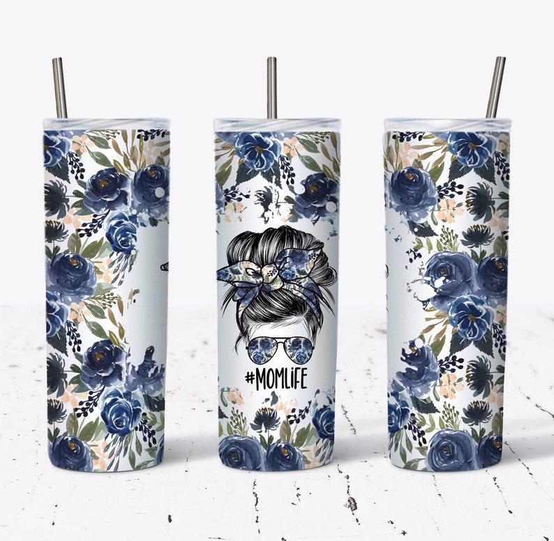 May include: Three stainless steel tumblers with a blue floral design and a black and white illustration of a woman with a messy bun and sunglasses. The tumbler in the middle has the text "#MOMLIFE" printed on it.