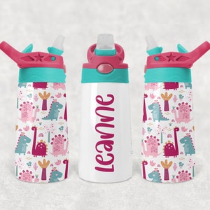 May include: A white stainless steel water bottle with a turquoise lid and pink straw. The bottle has a pink and turquoise dinosaur pattern and the name "Leanne" written in pink on the front.