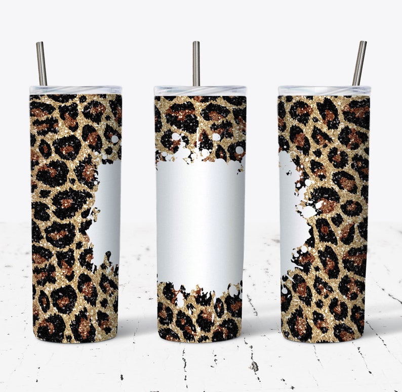 May include: Three stainless steel tumblers with lids and straws. The tumblers are decorated with a gold glitter leopard print pattern and white paint splatters.