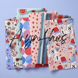 May include: Several folded fabrics with diverse patterns, including red stars, blue and red stripes, watermelon slices, and floral designs. The fabrics display the text "Aryn Haus" across their surfaces.