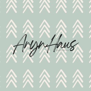 May include: A seamless pattern featuring rows of white arrow-shaped designs on a muted teal background. The text "Aryn Haus pattern co" is written in a stylish script font.