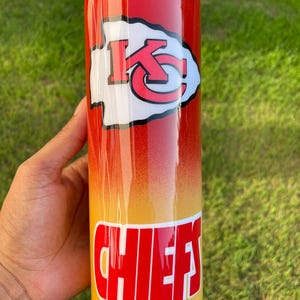 May include: A stainless steel tumbler with a red, orange, and yellow gradient design. The tumbler features the Kansas City Chiefs logo and the word "CHIEFS" in red block letters.