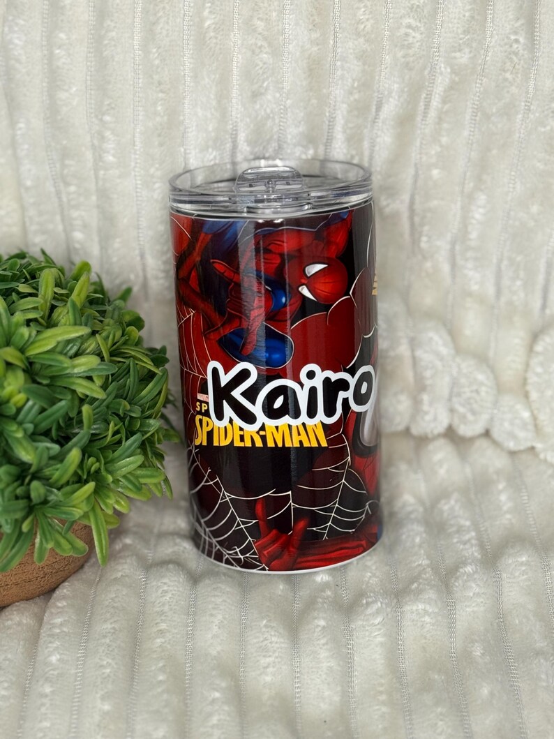 May include: A personalised tumbler with Spider-Man graphics. The tumbler is mainly red with a black spiderweb design and a blue and red Spider-Man illustration. The name "Kairo" is printed in white and yellow, with the words "Spider-Man" below.