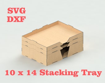 May include: A set of three 10 x 14 inch wooden stacking trays. The trays are made of light brown wood and have a simple design. The trays are stacked on top of each other, with the top tray slightly offset from the bottom two trays.