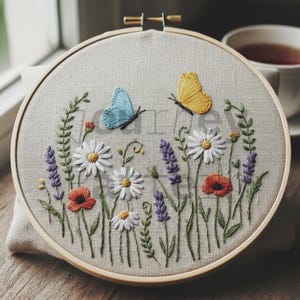 Pode incluir: Arte de bordado floral em forma de círculo com um campo de margaridas, papoilas e lavanda com duas borboletas. As borboletas são amarelas e azuis. O bordado está num círculo de madeira.