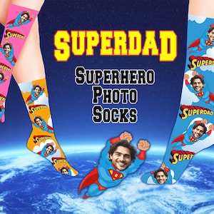 May include: Superdad Superhero Photo Socks with a blue, red, and yellow color scheme. The socks feature a superhero design with a person's face in the center of the design. The socks are available in a variety of colors and designs.