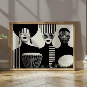 May include: A framed art print depicting three figures with striking black and white striped designs. Each figure holds a drum. The artwork is presented in a gold frame, set against a neutral wall, creating a bold visual statement.