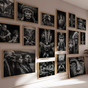May include: A collection of framed black and white art prints depicting Native American portraits and landscapes. The prints are displayed on a light-coloured wall with wooden frames.