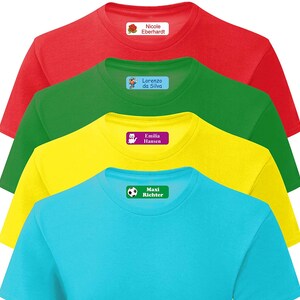 May include: Four colorful t-shirts with iron-on name labels. The labels feature a rose, a construction worker, a cat, and a soccer ball.