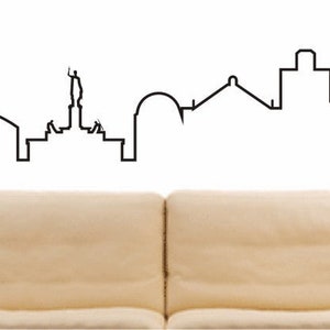 May include: Black and white line art cityscape silhouette of Nicosia, Cyprus. The skyline features a church, a tall building, and several other buildings.
