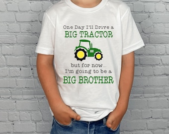 May include: White t-shirt with a green tractor graphic and the text "One Day I'll Drive a BIG TRACTOR but for now... I'm going to be a BIG BROTHER".