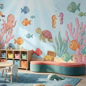 May include: A child's playroom with an ocean theme. The walls feature a mural of sea creatures, including fish, an octopus, and a turtle. The room includes a round table, chairs, a rug, and storage units. Plush sea creature toys are on the rug.