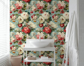 May include: Wallpaper featuring a dense floral pattern of large white and deep red roses with green leaves on a light blue background. The wallpaper is applied to a wall behind a white bathroom vanity with a white vessel sink and metal faucet.