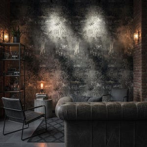 May include: A modern living room with a dark, industrial aesthetic. The focal point is a tufted leather sofa against a graffiti-covered wall. Additional elements include a metal shelving unit, a chair, and a small rug, all illuminated by spotlights.
