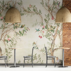 May include: A cafe interior featuring a floral mural with birds, tables, and chairs. Two woven pendant lights hang above the tables. The wall on the right is brick, and the floor is white.