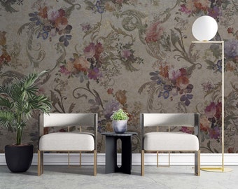 May include: Two white chairs with gold metal frames and a black side table in front of a wall with a floral wallpaper pattern.