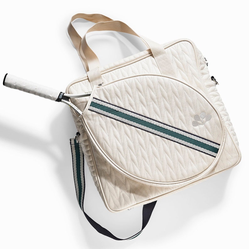 Tennis bag in quilted white vegan leather with wimbledon green webbing and solid silver metal pullers.