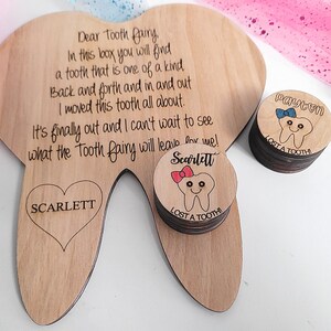May include: Wooden tooth-shaped box with engraved text and a heart with the name "SCARLETT". Includes a stack of small wooden circles with a tooth graphic and the names "Payton" and "Scarlett".