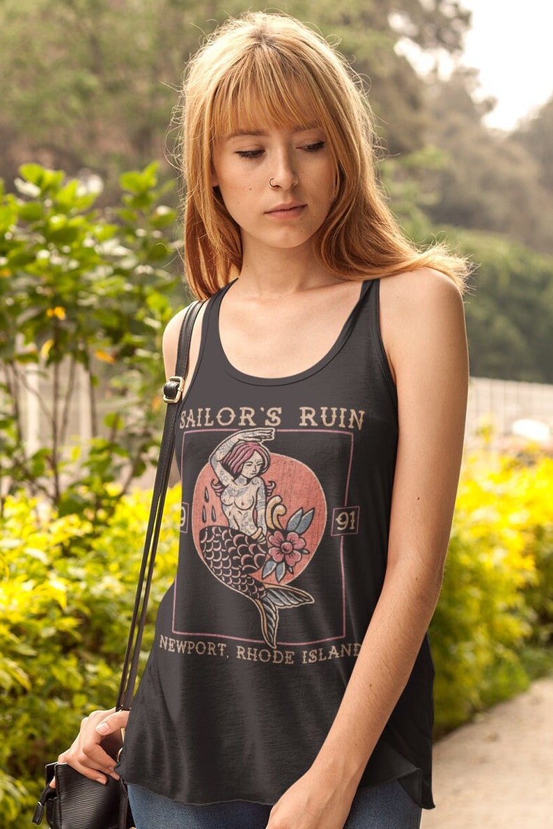 May include: Black tank top with a vintage-style graphic of a mermaid with the text "Sailor's Ruin" and "Newport, Rhode Island" printed on the front.