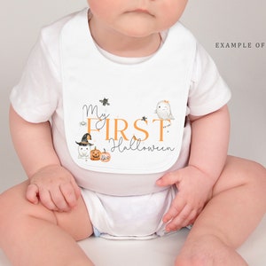 May include: A white baby bib featuring the text My FIRST Halloween in orange and black script. The design includes illustrations of a small ghost wearing a witch hat, a jack-o'-lantern with the word Boo, a bat, a spider, and a winking ghost.