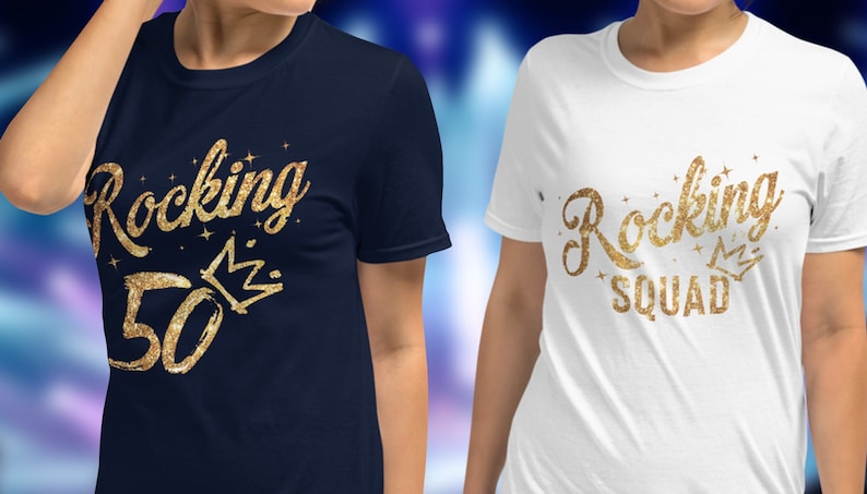May include: Two t-shirts with gold glitter text. One shirt is navy blue with the text "Rocking 50" and a crown. The other shirt is white with the text "Rocking Squad" and a crown.