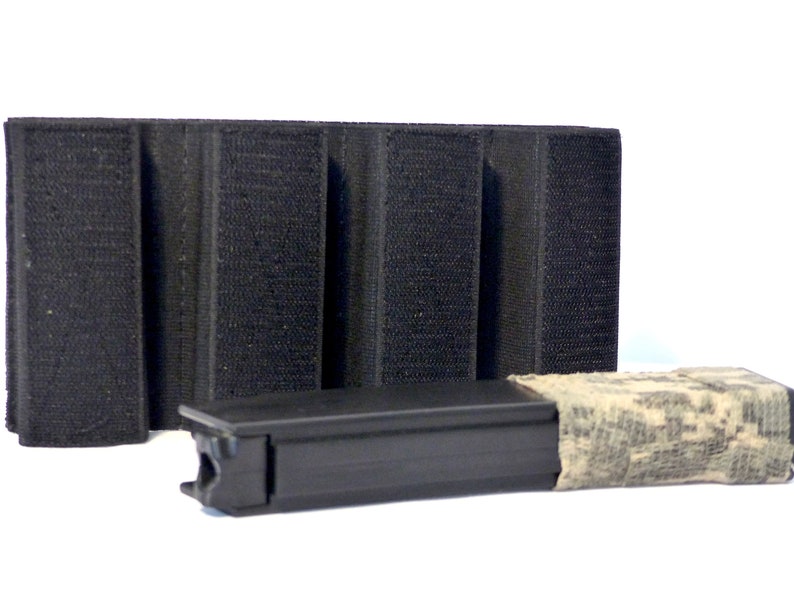 May include: A black magazine pouch with three rows of hook and loop fasteners. A black magazine with a camouflage wrap is shown next to the pouch.
