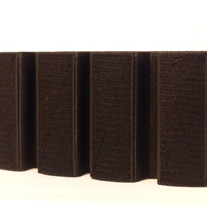 May include: Five black hook and loop fastener strips, each with a textured surface.