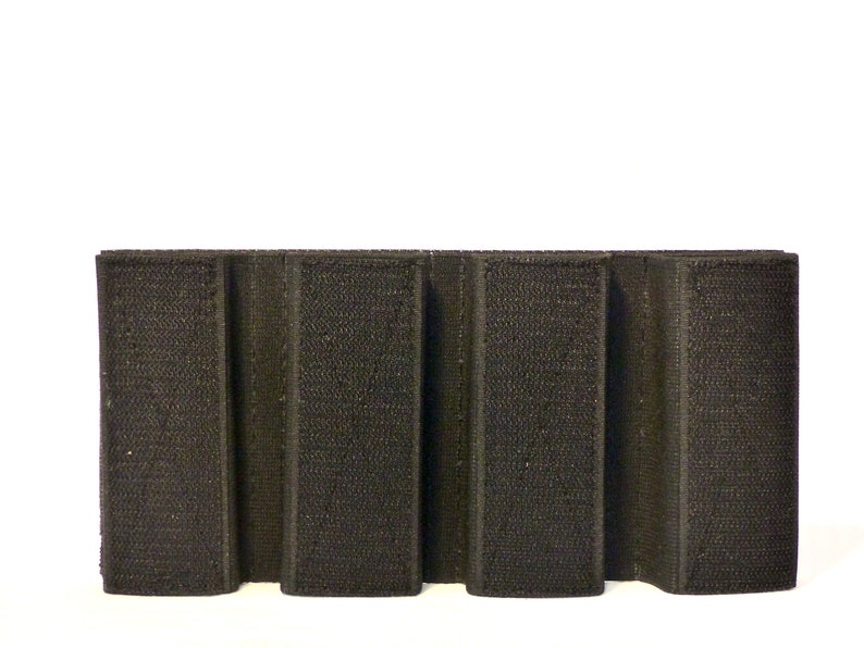 May include: Black velcro panel with five vertical slots for attaching accessories.