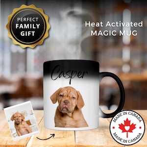 May include: A heat-activated magic mug with a black top that fades to white, featuring a brown puppy named Casper. The mug has a black handle and the text "Heat Activated MAGIC MUG". A "Perfect Family Gift" emblem is also visible.
