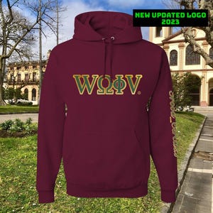 May include: A maroon hooded sweatshirt with a front pocket. The front displays the text "WΩΦV" in gold and green. The sleeve has the text "Srood_Queens" in gold. The top right corner has the text "NEW UPDATED LOGO 2023" in green.