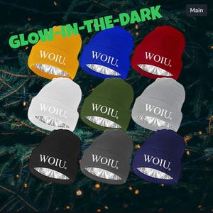 May include: Eight beanies in a range of colours: yellow, blue, red, white, green, grey, black, and navy. Each beanie features the word "WOIU" and a silver lining. The text "GLOW-IN-THE-DARK" is displayed above the beanies.