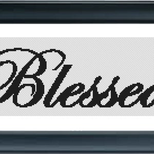 May include: Black and white cross stitch pattern with the word "Blessed" in a cursive font.
