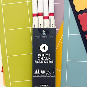 May include: A package of four white chalk markers with red accents, labeled "White Chalk Markers." The packaging includes the text "Kaleidoscope Living" and instructions for use. The markers are designed for use on non-porous surfaces.