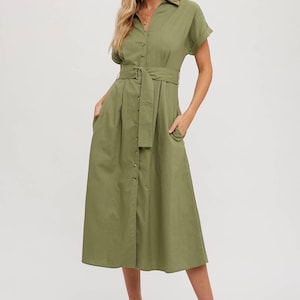 May include: A green midi-length shirt dress with a button-up front, short sleeves, and a matching belt. The dress has a collared neckline and two pockets.