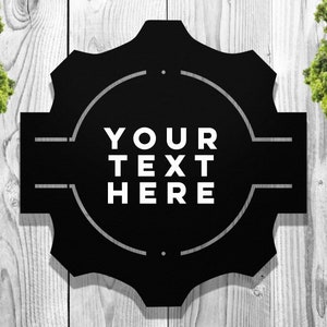 May include: Black metal sign with a circular design and the text "YOUR TEXT HERE" in white.