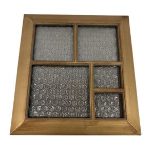 May include: A square, gold-colored picture frame with multiple rectangular openings. The openings are filled with clear bubble wrap. The frame has a simple, classic design, suitable for displaying photos or artwork.