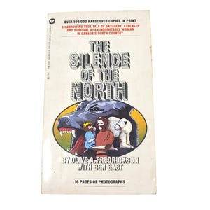 May include: A vintage paperback book titled "The Silence of the North." The cover features a wolf, people, and polar bears in an oval frame. The book's title is in large, bold letters, with text above and below the title.