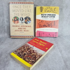 May include: Three vintage books with colorful covers. The titles include "Once They Moved Like The Wind," "How Indians Really Lived," and "Great Western Indian Fights." The books feature illustrations and text related to Native American history and culture.