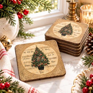 May include: A set of square coasters featuring a vintage-style illustration of a decorated Christmas tree centred on a background of musical sheet notes. The text "We Wish You A Merry Christmas And A Happy New Year" is printed around the tree.