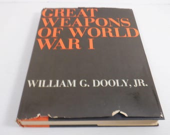 May include: A hardback book titled "Great Weapons of World War I" by William G. Dooley, Jr. The book has a black cover with orange lettering. The book's edges show signs of wear.