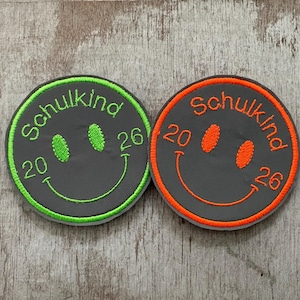 Reflektierender Klett Patch, mit Smiley Schulkind 2026, Kletties, Schulranzen, Schultüte,  Refrektor Klettie, Adventskalender