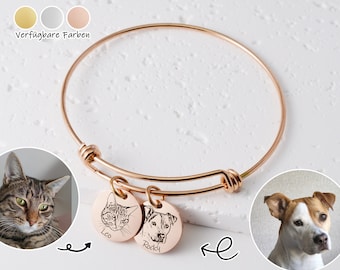 May include: A rose gold expandable bangle bracelet with two engraved charms. The charms feature black and white images of a cat and a dog with their names "Leo" and "Rocky" engraved below.