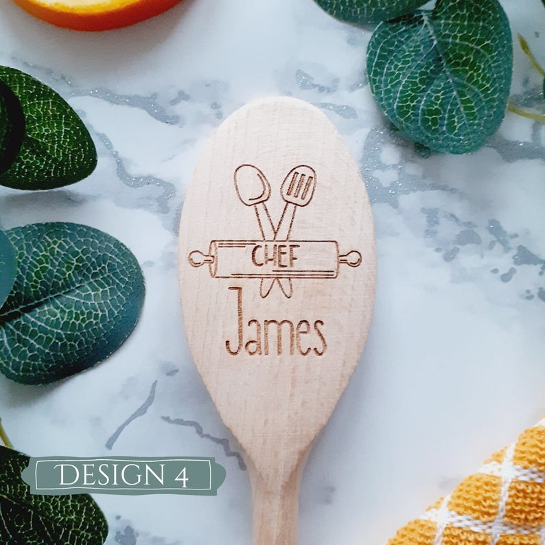 May include: Wooden spoon with a design of a rolling pin, two spoons, and the word "CHEF" engraved on it. The name "James" is also engraved on the spoon.