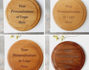 May include: Four wooden round coasters with a natural wood finish. Each coaster has the text "Your Personalisation or Logo Here" engraved on the top.
