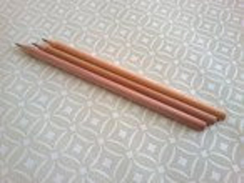 May include: Three wooden pencils with unsharpened ends.