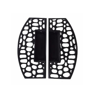May include: A pair of black metal door handles with a unique, organic, honeycomb-like design. The handles have a rectangular cutout in the centre.